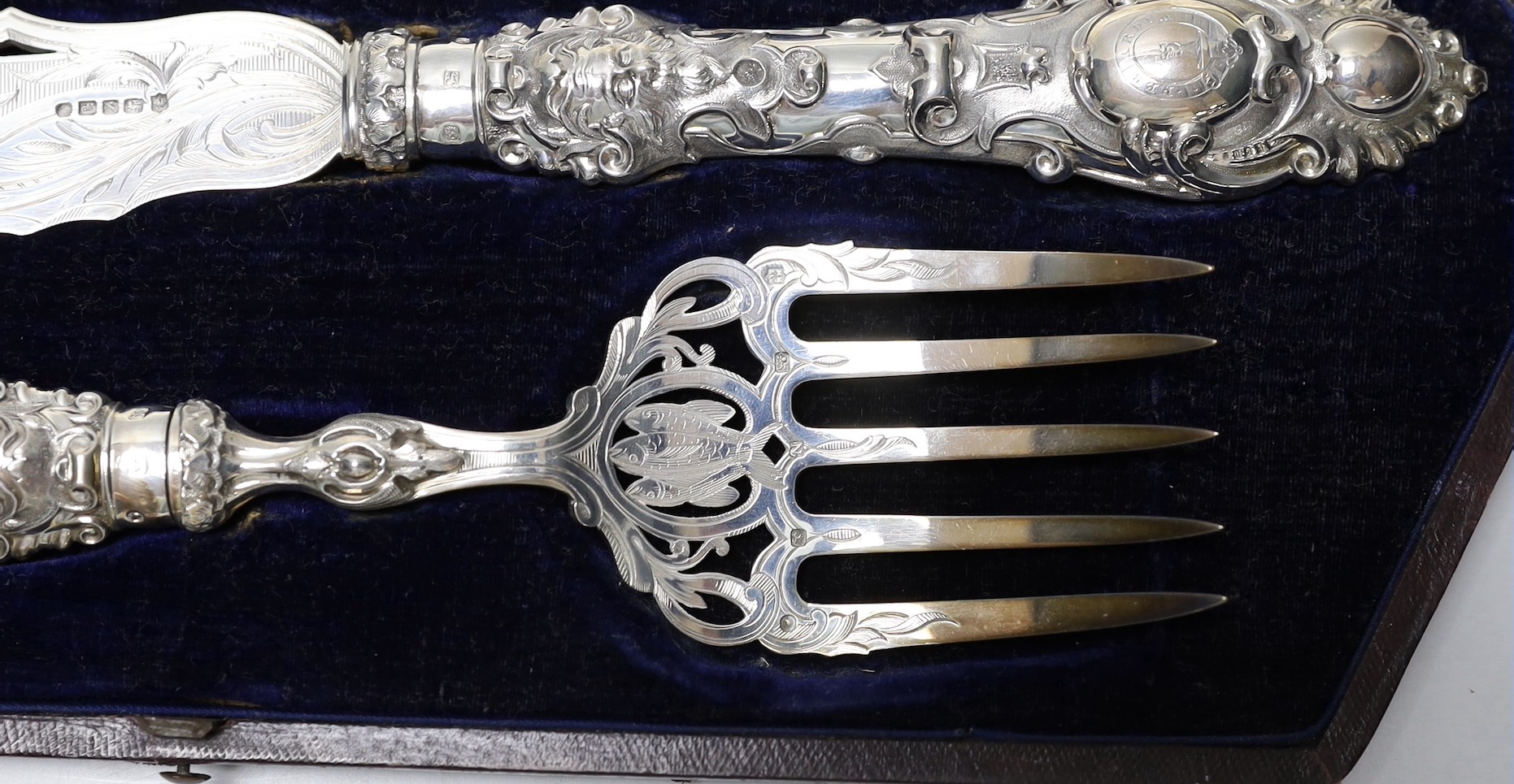 A cased pair of ornate Victorian silver fish servers, Martin, Hall & Co, Sheffield, 1856, knife 35.8cm.